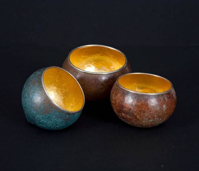 Small spherical vessels in bronze and 24 karat gold by David Huang